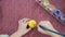 Close-up, drawing an Easter pattern on a yellow egg