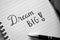 Close-up of `Dream Big` brush calligraphy in notebook