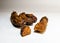 Close-up of dried bananas, cut off a piece of a banana on white background gradient