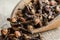 Close up dried cloves in wooden shovel on burlap sack