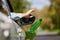 Close Up Of Driver In Car Dropping Trash Out Of Window On Country Road