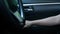 Close-up of Driver`s hand closing the car door and pressing on button switch electric lock doors in car for safety. Technology and