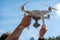 Close up of drone pilot preparing to fly outdoors. Remote controlled drone robot