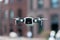 Close up of drone quadcopter inflight. Cityscape background