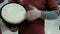 Close-up of a drummer\'s hand. Ethnic music in a modern building interior. Real sound and rhythm. Percussion musical instrument, wh