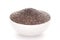 Close-up of dry organic chia seed salvia hispanica  in a white ceramic bowl over white background