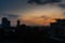 Close up dry water and stains on glass wall with twilight sky, clouds and shadow of buildings background.