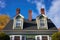 close-up of dual chimneys atop a colonial home