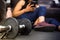 Close up dumbbell and girl resting using the mobile. Concept of sport and training at home. Online personal trainer on mobile