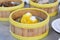 Close up dumpling Dim sum in the steam basket. Delicious chinese snack. Boiled Quail egg wrap with wonton sheet on table in