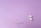 Close up  Earphones on isolate purple pastel background.