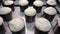 Close-up of easter cakes ready for baking. Stock footage. Easter raw cakes with raisins in molds are on baking tray