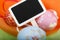 Close-up of Easter eggs and blackboard on colourful velvet