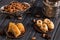 Close up. Eastern still life. Assortmant traditional homemade baklava. Turkish pottery and silverware. Dark wooden background