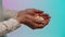Close up for eastern young woman hands giving many small seashells to man hands, barter concept. Stock. Eastern woman in