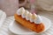 Close Up of eclair on a white plate.