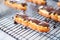 close-up of eclairs with shiny chocolate glaze on a cooling rack