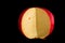 Close up. Edam cheese head in a cut. Isolated on black background