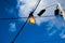 Close up of an Edison-style filament on a light bulb against a cloudy sky. Energy crisis