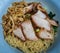 Close-up of Egg Noodle with Sliced red roasted pork and Wonton, Streaky pork with crispy crackling in blue bowl