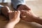 Close up elder woman giving hands to compassionate husband.