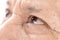 Close-up of elderly asian man eyes with wrinkle on face