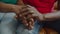 Close-up of elderly black couple holding hands
