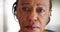 A close-up of a elderly black woman looking sad