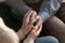 Close up of elderly couple hold hands showing love