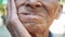 Close up of Elderly man biting on cotton gauze after tooth extraction, Tooth decay from not like brushing teeth. Oral care concept