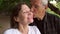 Close-up of an elderly man gently kisses his wife.