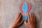 A close up of an elderly man holding a paper air baloon on a wooden table. Concept of thinking about childhood dreams, sadness and