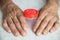 Close-up of an elderly man`s hand and a container for testing. Health care in old age. Selective focus