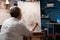 Close up of elderly woman drawing vase on canvas with pencil