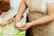 A close-up of an elderly woman`s hand with a test. Cooking muffins at home