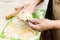 A close-up of an elderly woman`s hand with a test. Cooking muffins at home