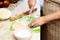 A close-up of an elderly woman`s hand with a test. Cooking muffins at home