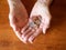Close Up of Elderly Woman`s Hands Holding Coins