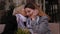 Close-up of an elderly woman whispering something in the ear of her daughter.