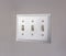 Close up of the electrical light switch against the white wall of a house