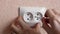 Close-up of an electrician installs a new white electrical outlet indoors. Repairing home electricity. Replacing the socket with y