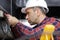 close-up electrician measuring voltage cable on ceiling indoors