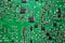 Close-up of an electronic printed green computer circuit board.