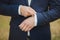 Close-up of elegance male hands wearing modern suit