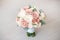 Close-up elegant bouquet of flowers with roses diathus carnation bohemia chrysantemum on light background indoors