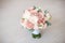 Close-up elegant bouquet of flowers with roses diathus carnation bohemia chrysantemum on light background indoors