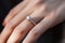 Close up of an elegant diamond ring on young woman finger