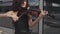 Close up of Elegant woman in black dress playing violin near glass building