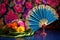 close up of an embellished hand fan and a cocktail with vibrant umbrella