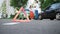 Close-up of an emergency sign against the background of arguing people at the colliding cars.